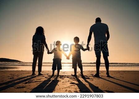Family silhouette at the beach, holding hands at sunrise and people with love, care and support outdoor. Mom, dad and kids travel, back and ocean view with parents and children outdoor in nature