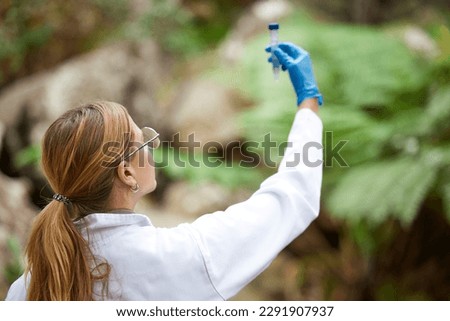 Science, nature and woman with sample for inspection, environmental and ecosystem study. Agriculture, biology and female scientist with test tube in forest for analysis, research and climate change Royalty-Free Stock Photo #2291907937