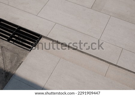 Drain on ceramic floor tile.non slip ceramic tiles with steel gutter. Royalty-Free Stock Photo #2291909447