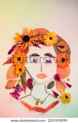 romantic woman face with purple hair made from colorful leaves and bright flowers on white background