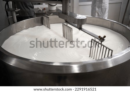 Process of making dairy products in modern dairy factory. Preparing milk for cheese, pasteurization in large tanks. Copy space Royalty-Free Stock Photo #2291916521
