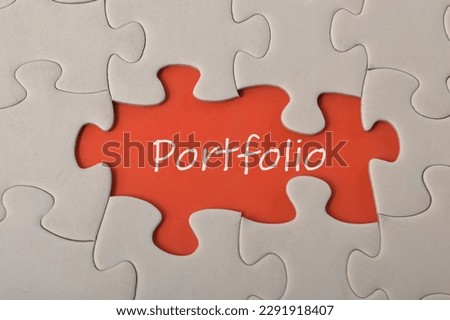Missing jigsaw puzzle with text PORTFOLIO.A portfolio typically refers to a collection or selection of items or assets, such as investments, artwork, projects, or samples of work.