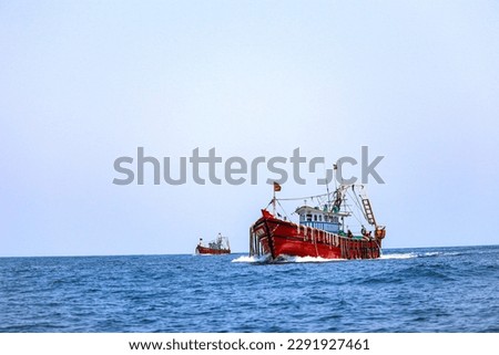 closeup picture of one red boat moving on an ocean
