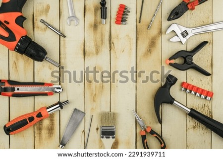 Tools for assembly and repair on the table. Working tools on a wooden rustic background. View from above Royalty-Free Stock Photo #2291939711