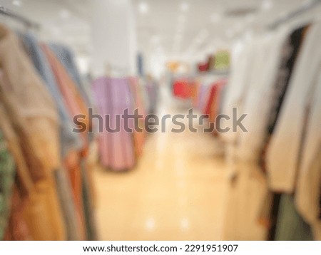 Defocused Abstract Background aisle of female robe (Muslimah appare) and clothes hanging on rack in the store or Shopping Center. with vintage tone effect

