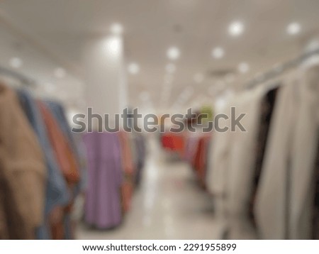 Defocused Abstract Background aisle of female robe (Muslimah appare) and clothes hanging on rack in the store or Shopping Center. 