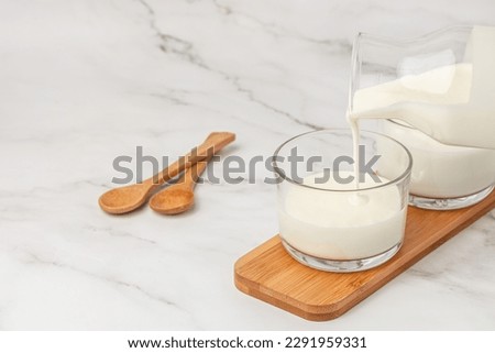 lactose free yogurt, kefir, fermented milk on a light background. Healthy, clean eating. Vegan or gluten free diet, Royalty-Free Stock Photo #2291959331