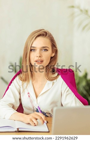 young beautiful college student girl studying busy for university exam, worried desperate and in stress feeling tired and test pressure sitting on desk with book in youth education concept.