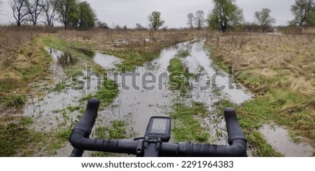 Gravel bike stopped by flooding at the grassland road