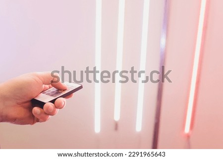 LED strip in purple colors and a control panel for switching colors Royalty-Free Stock Photo #2291965643