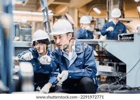 Factory worker checking for safety by pointing