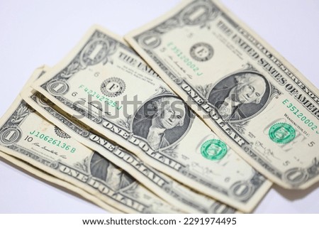 United States one dollar bills in close-up photo. White background.
