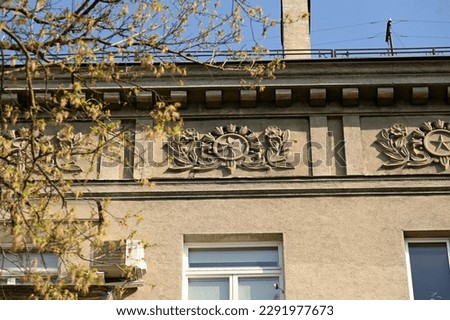ornate cornice of a historic building with large decorations below it