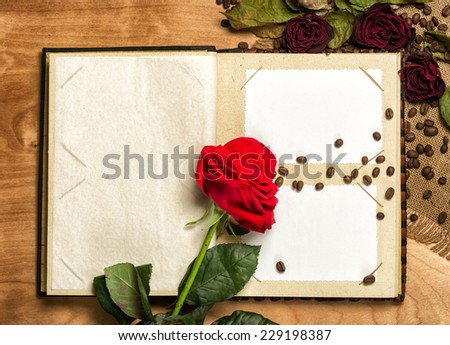 photo album and red roses on coffee seeds