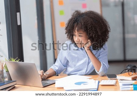 Female Entrepreneur. Cheerful African American Businesswoman Working On document and Laptop In Modern Office. Empty Space