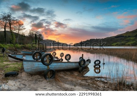 Beautiful sunrise over boats at Glencar Lough near Sligo in Ireland
