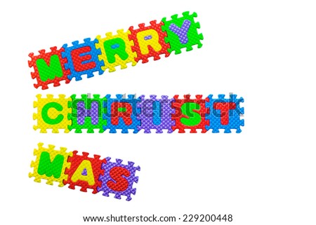 Merry Christmas sign made out of alphabet puzzle pieces isolated on white background