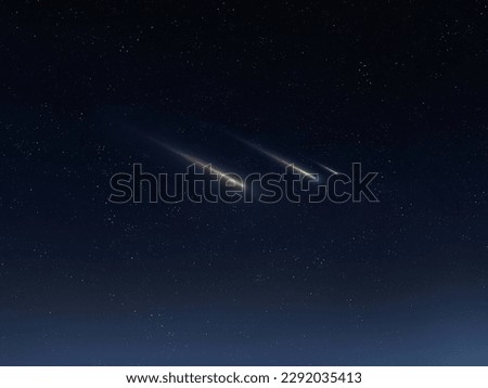 Beautiful shooting stars in the sky. Meteors on a dark background. Meteorites glow in the atmosphere. Royalty-Free Stock Photo #2292035413