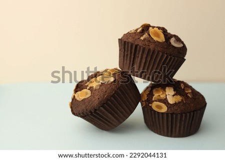 fragrant homemade
chocolate cupcake with walnuts on a light background. for banners, postcards, napkins, flyers, business cards, screensavers, labels, etc.