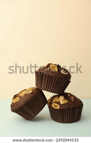 fragrant homemade
chocolate cupcake with walnuts on a light background. for banners, postcards, napkins, flyers, business cards, screensavers, labels, etc.