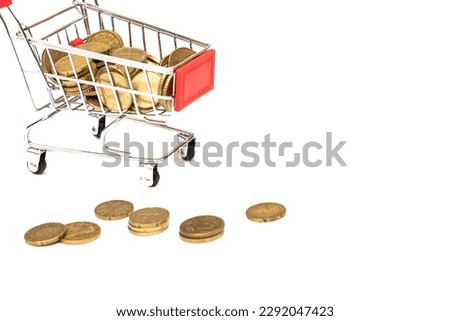 Shopping cart full of coins on white background, shopping concept