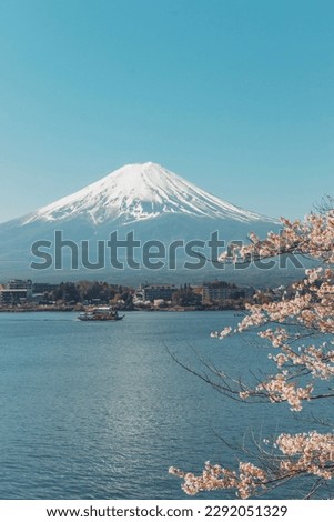 A representative spring landscape of Japan with cherry blossoms in full bloom and Mt. Fuji seen from Lake Kawaguchi in Yamanashi Prefecture. Royalty-Free Stock Photo #2292051329