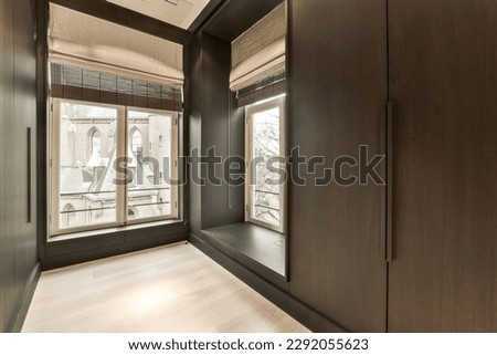 an empty room with wooden floors and large windows that look out onto the cityscapea photo taken from inside