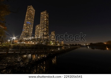 Wide angle long exposure shot of highrise modern luxury buildings at the waterfront at night.