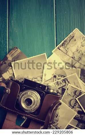 Vintage photo camera and old photos.