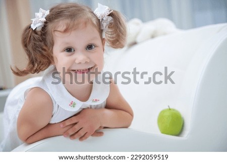 Portrait of little girl with teddy bear on white background