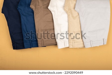 Chino Pants Isolated On Brown background. Hanged Cotton Pants. Trouser. Royalty-Free Stock Photo #2292090449