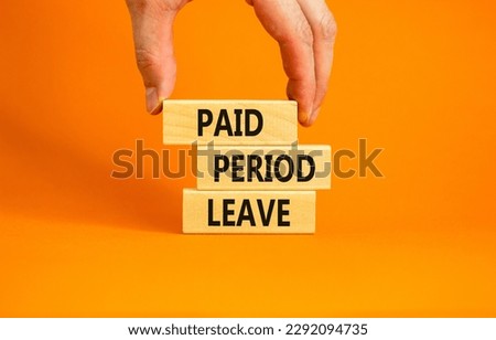 Paid period leave symbol. Concept words Paid period leave on wooden blocks. Beautiful orange table orange background. Doctor hand. Business medical paid period leave concept. Copy space.