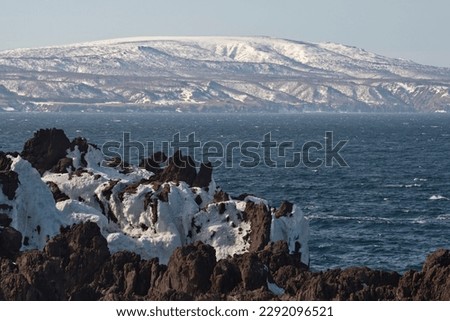 Russia. Far East, Kuril Islands. Very hard and sharp basalt rocks along the coast of the Sea of Okhotsk on the island of Iturup. Royalty-Free Stock Photo #2292096521