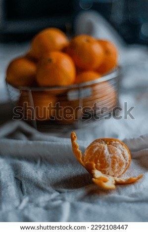 peeled tangerine on the background of a basket with tangerines