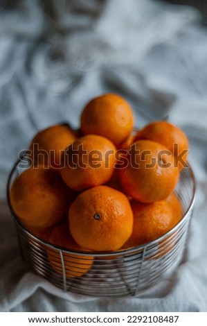 metal basket with tangerines close-up