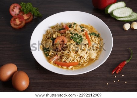 Mee rebus, also known as mie rebus in Indonesian spelling, is a Maritime Southeast Asian noodle soup dish. Literally translated as "boiled noodles". Royalty-Free Stock Photo #2292112909