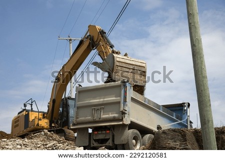 excavator shovel loading dump truck hydraulic heavy equipment lorry construction site Royalty-Free Stock Photo #2292120581