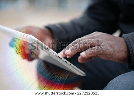 African american man uses tablet computer. Black man hands holds tablet pc, close up. African works with tablet computer, flips through feed on social networks