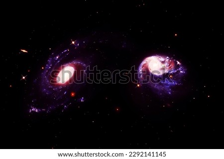 Two galaxies in space on a dark background. Elements of this image furnished NASA. High quality photo