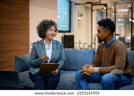 Female financial advisor having a meeting with African American man in the office. Royalty-Free Stock Photo #2292141993