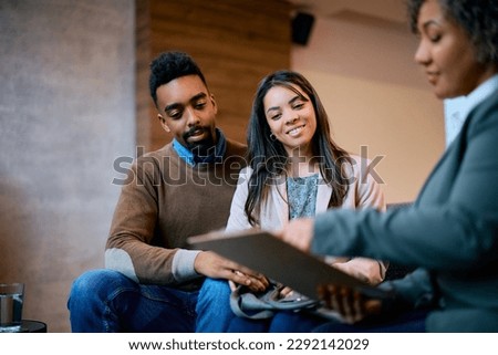 Young African American couple having a meeting with their financial advisor in the office. Royalty-Free Stock Photo #2292142029