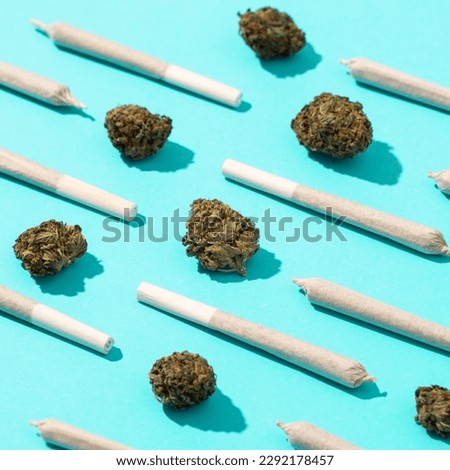 Cannabis joint pattern with flower on blue background. Concept of medical cannabis, therapeutic cannabis, alternative medicine