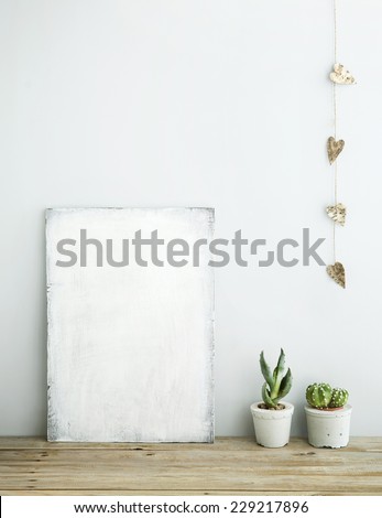 Scandinavian style home decoration. Old wooden poster with succulents in concrete pots.