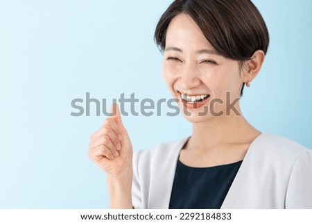 Asian businesswoman on blue background