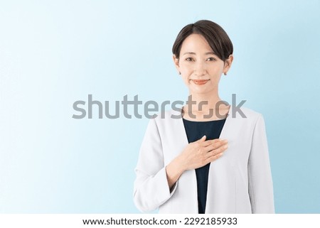Trusted Asian Businesswoman on blue background Royalty-Free Stock Photo #2292185933