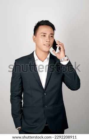 handsome Asian businessman talking mobile phone isolated on studio white background.