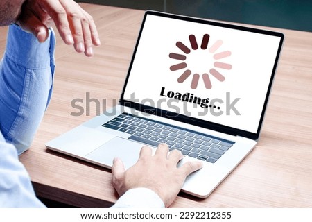 Businessman raise your hand with icon loading on display laptop Royalty-Free Stock Photo #2292212355