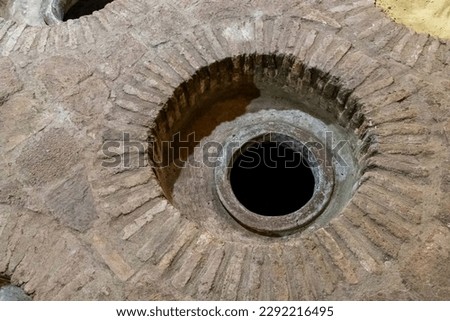Kveri wine cellar in georgia. Wine storage is a special production of alcohol in the industry. Stone floor. Hole in the ground. Wine production in the winery. Georgian wine production. Royalty-Free Stock Photo #2292216495