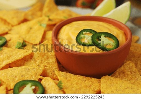 Corn tortilla chips with cheese sauce	 Royalty-Free Stock Photo #2292225245