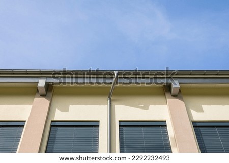 View of the upper part of the facade at the junction with the roof slope. Royalty-Free Stock Photo #2292232493